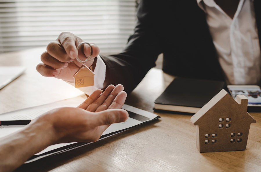 Realtor handing over keys to new resident